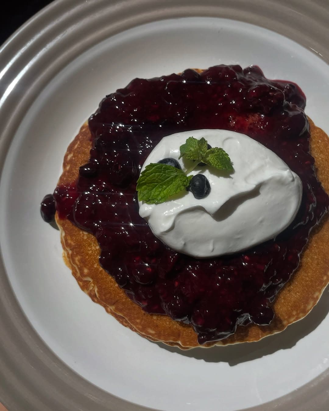 Hot cakes con compota de moras azules y crema batida